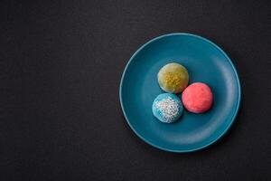Delicious colorful asian mochi sweets with rice dough shell and fruit filling photo