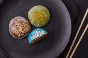 Delicious colorful asian mochi sweets with rice dough shell and fruit filling photo