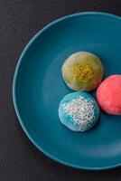 Delicious colorful asian mochi sweets with rice dough shell and fruit filling photo