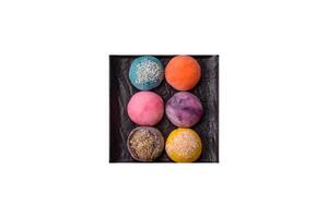 Delicious colorful asian mochi sweets with rice dough shell and fruit filling photo