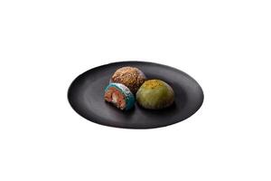 Delicious colorful asian mochi sweets with rice dough shell and fruit filling photo