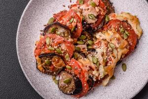 Rings of eggplant, tomato and zucchini with pieces of chicken and garlic photo