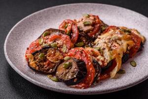 Rings of eggplant, tomato and zucchini with pieces of chicken and garlic photo
