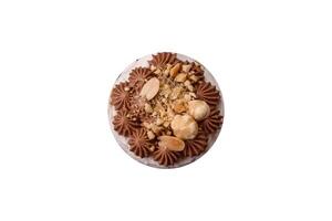 Sweet puff tart with meringue, cream and nuts photo