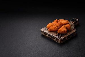 Brie cheese or camembert fries in breading, fast food, takeaway photo