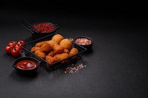 Brie cheese or camembert fries in breading, fast food, takeaway photo