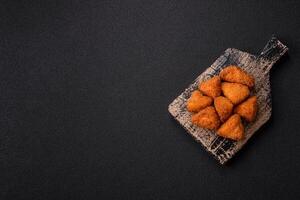 Brie cheese or camembert fries in breading, fast food, takeaway photo