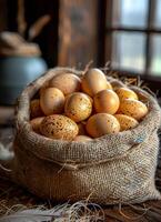 Freshly gathered speckled eggs in a burlap sack A burlap sack overflows with warm, speckled eggs, showcasing a rustic and inviting kitchen setting during daylight. photo
