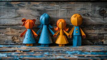 Colorful paper dolls on a rustic wooden table A set of four handcrafted paper dolls in vibrant colors stands on a weathered wooden table, showcasing creativity and craftsmanship. photo