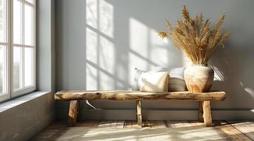 Cozy minimalist nook with wood bench A sunlit corner displays a rustic wooden bench adorned with pillows and a vase of dried plants, enhancing the serene atmosphere. photo
