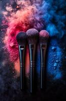 Artistic arrangement of colorful brushes. Three makeup brushes are positioned strategically with vibrant colored powders scattered around them, creating an artistic display. photo