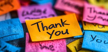 Bright sticky notes showing gratitude. Brightly colored sticky notes scattered on a surface convey messages of appreciation, creating a vibrant and cheerful atmosphere. photo