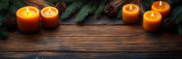 Candles on a rustic pine table. Warm orange candles are placed on a wooden table surrounded by pine branches and cones, creating a cozy atmosphere. photo