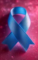 Blue ribbon for awareness and support. A vibrant blue ribbon stands out against a pink background, representing awareness and support for important causes. photo