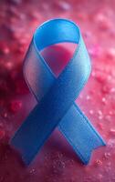Blue ribbon symbolizing awareness and support. A delicate blue ribbon rests on a textured surface, representing awareness for various causes, illuminated softly by light. photo