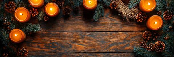 Candles with pine and cones decor. A cozy arrangement featuring glowing candles, pine branches, and cones on a wooden surface creates a warm, inviting atmosphere. photo