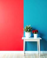 A table with two potted plants in front of a red and blue wall photo