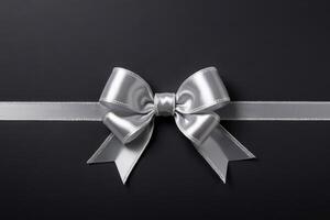 decorative ribbon bow silver string black background photo
