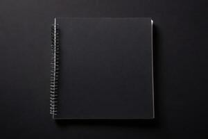 elevated view spiral notepad black background photo