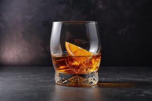 front view whiskey with orange cognac glass with copy space photo