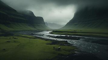 A river flows through a green valley under a dark sky photo