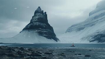 A boat is in the water near a mountain photo