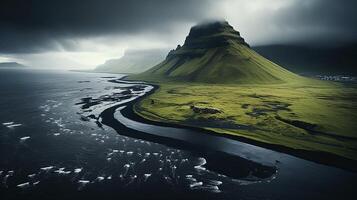 A large green mountain with black water and clouds photo