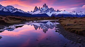 The mountains are reflected in the water at sunset photo