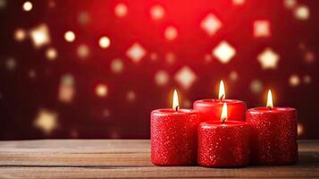 Three red candles on a wooden table with a red background photo