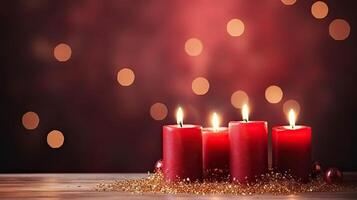 Three red candles on a wooden table with a bokeh effect photo