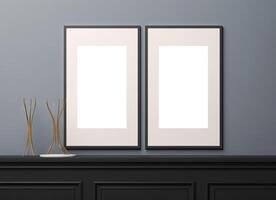 Two blank frames on a wall with a vase photo