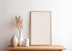 Mock up of a blank white frame on a wooden table with vases and pampas photo