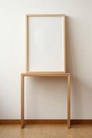 A wooden frame sits on a table in front of a white wall photo