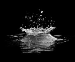 Water splashing on black background creating crown shape photo