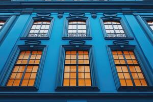 Elegant classical european building facade with arched windows reflecting sky photo