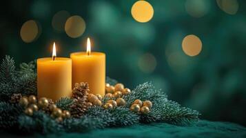 Burning candles creating festive christmas atmosphere with pine branches and pine cones photo