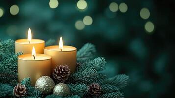 Burning advent candles with evergreen branches and pine cones on green background photo