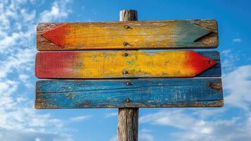 Empty wooden signpost with colorful arrows pointing in different directions photo