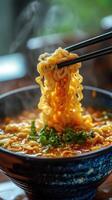 Chopsticks lifting noodles from bowl of hot steaming ramen photo