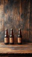 Three beer bottles standing on a rustic wooden table photo