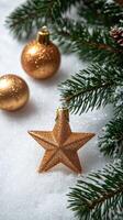 Christmas border composition with golden shiny decorations and fir branches covered in snow photo