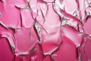 Crumpled pink material reflecting silver light creating abstract pattern photo
