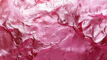 Pink metallic paint cracking forming abstract pattern background photo