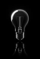 Light bulb reflecting on dark background symbolizing innovation photo