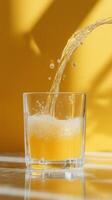 Side View of Yellow Liquid with Foam Pouring Beautifully Between Transparent Glasses photo