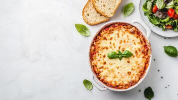Delicious Homemade Lasagna with Fresh Salad and Bread on a White Background - Perfect Dinner Concept photo
