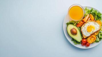 Healthy Lunch Break with Fresh Avocado, Egg Toast, and Orange Juice on a Light Blue Background photo