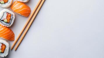 Delicious Sushi Lunch Break with Salmon Nigiri and Sushi Rolls on a Minimalist White Background with Chopsticks photo