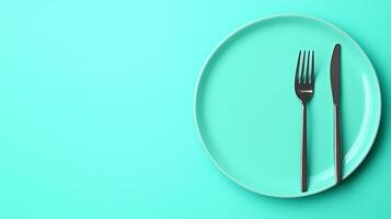 Elegant Dinner Concept with Minimalist Plate, Fork, and Knife on a Vibrant Turquoise Background photo