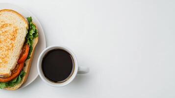 Delicious Sandwich and Coffee on a White Table - Perfect Lunch Break Setup with Copy Space photo